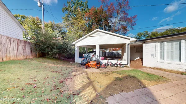 a view of a house with backyard sitting area and garden