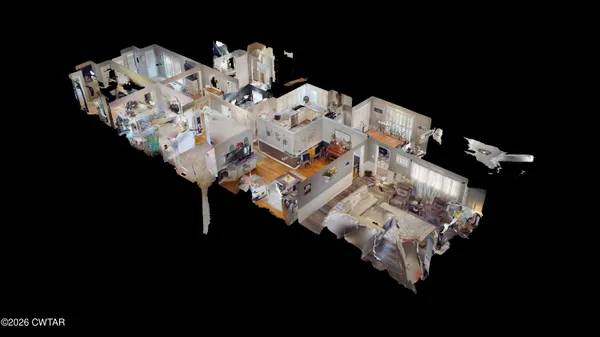 a bed sitting in a bedroom next to a lamp