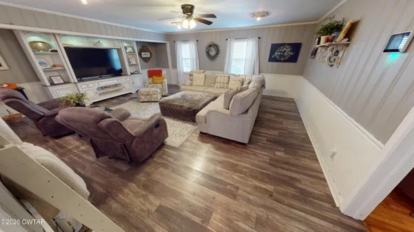 a living room with furniture and a flat screen tv