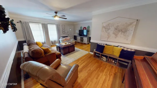 a living room with furniture and wooden floor