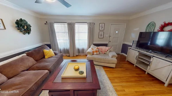 a living room with furniture and a flat screen tv