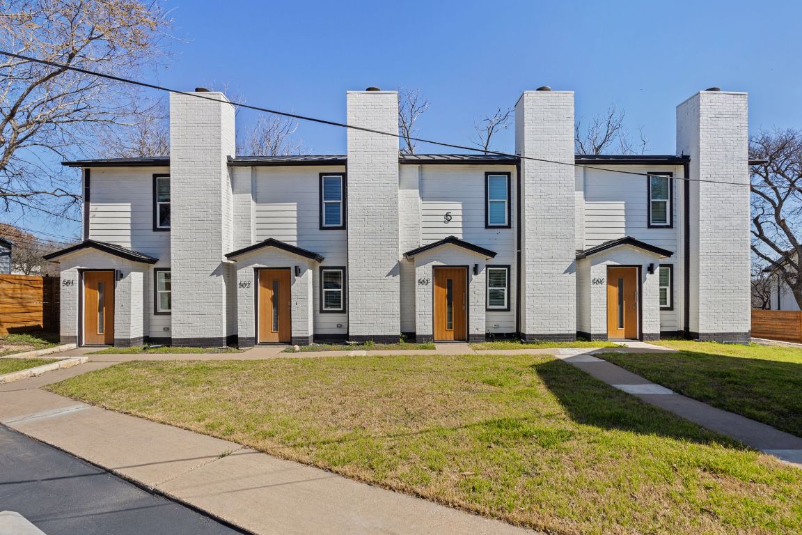 a large building with a big yard and more windows