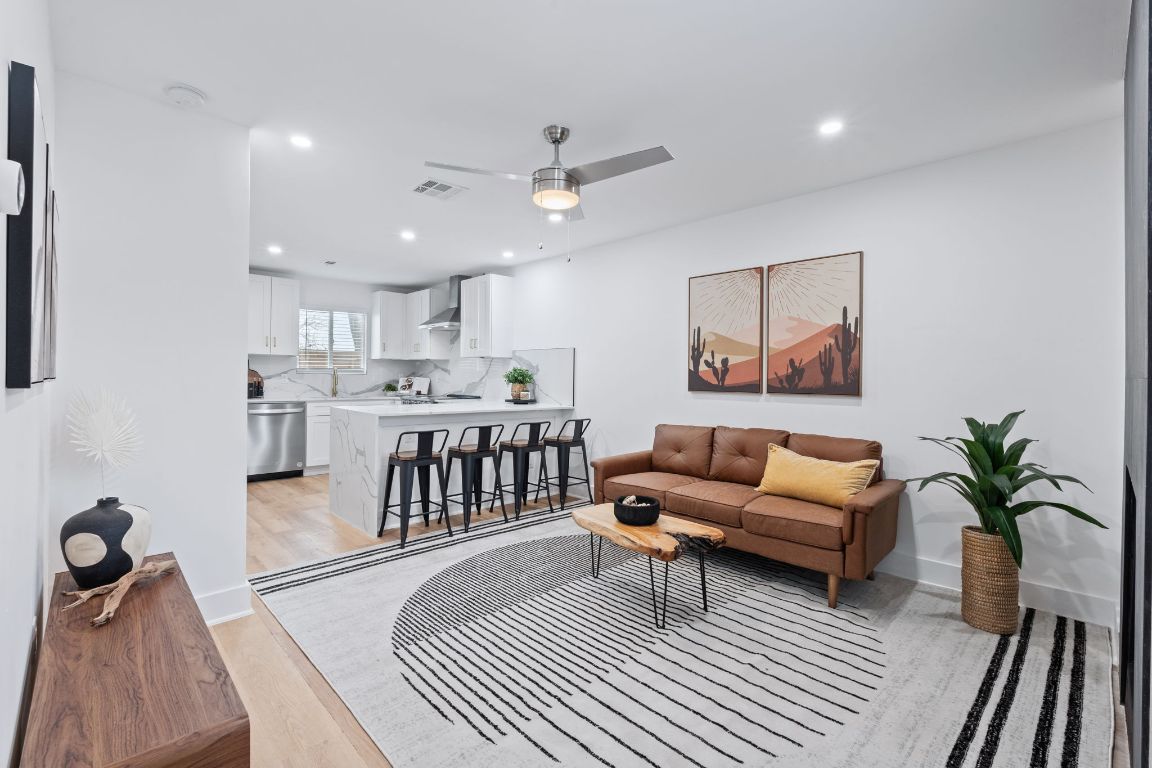 2706 Wheless Lane, Unit BLDG 5 Austin, TX 78723 - Photo 2 of 12 a living room with furniture a rug and kitchen view