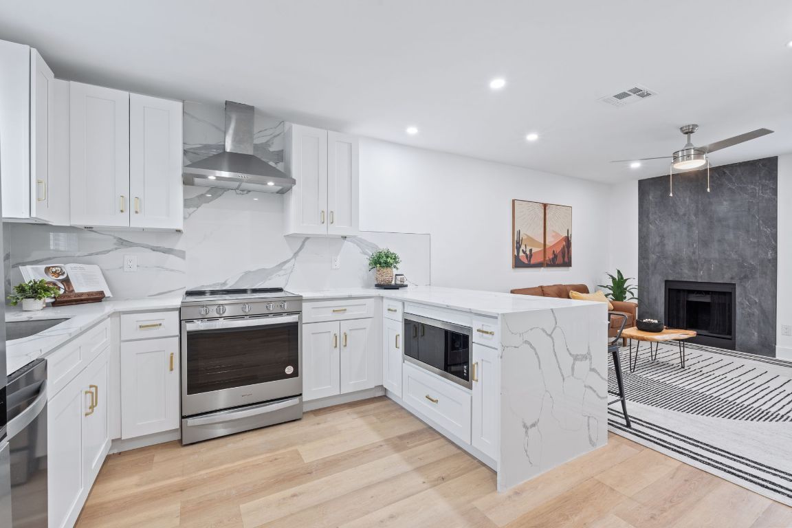 2706 Wheless Lane, Unit BLDG 5 Austin, TX 78723 - Photo 4 of 12 a kitchen with stainless steel appliances granite countertop a stove a sink and a refrigerator