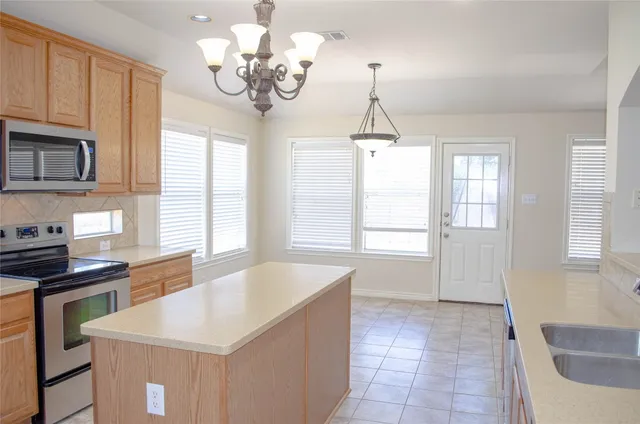 a kitchen that has a lot of cabinets furniture and a window