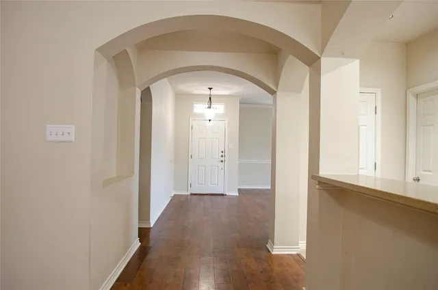 a view of a hallway with wooden floor