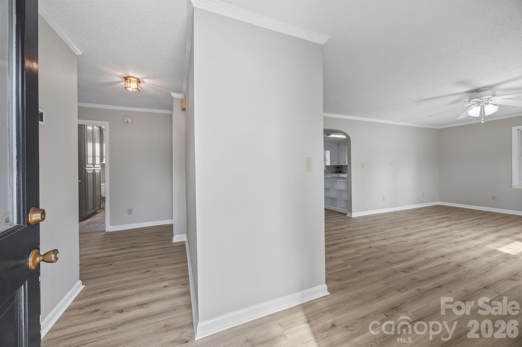 33633 Mann Road Albemarle, NC 28001 - Photo 13 of 39 a view of a hallway with wooden floor and staircase