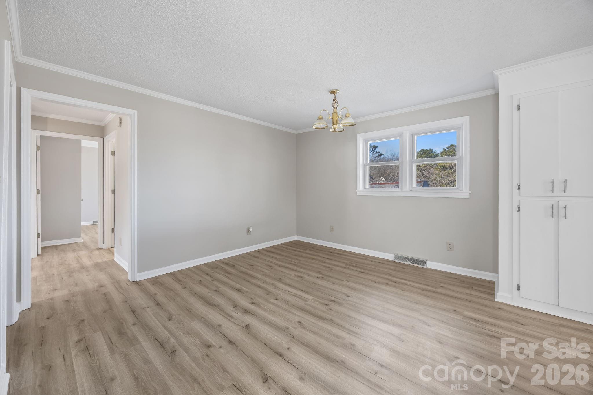 33633 Mann Road Albemarle, NC 28001 - Photo 18 of 39 a view of an empty room with wooden floor and a window