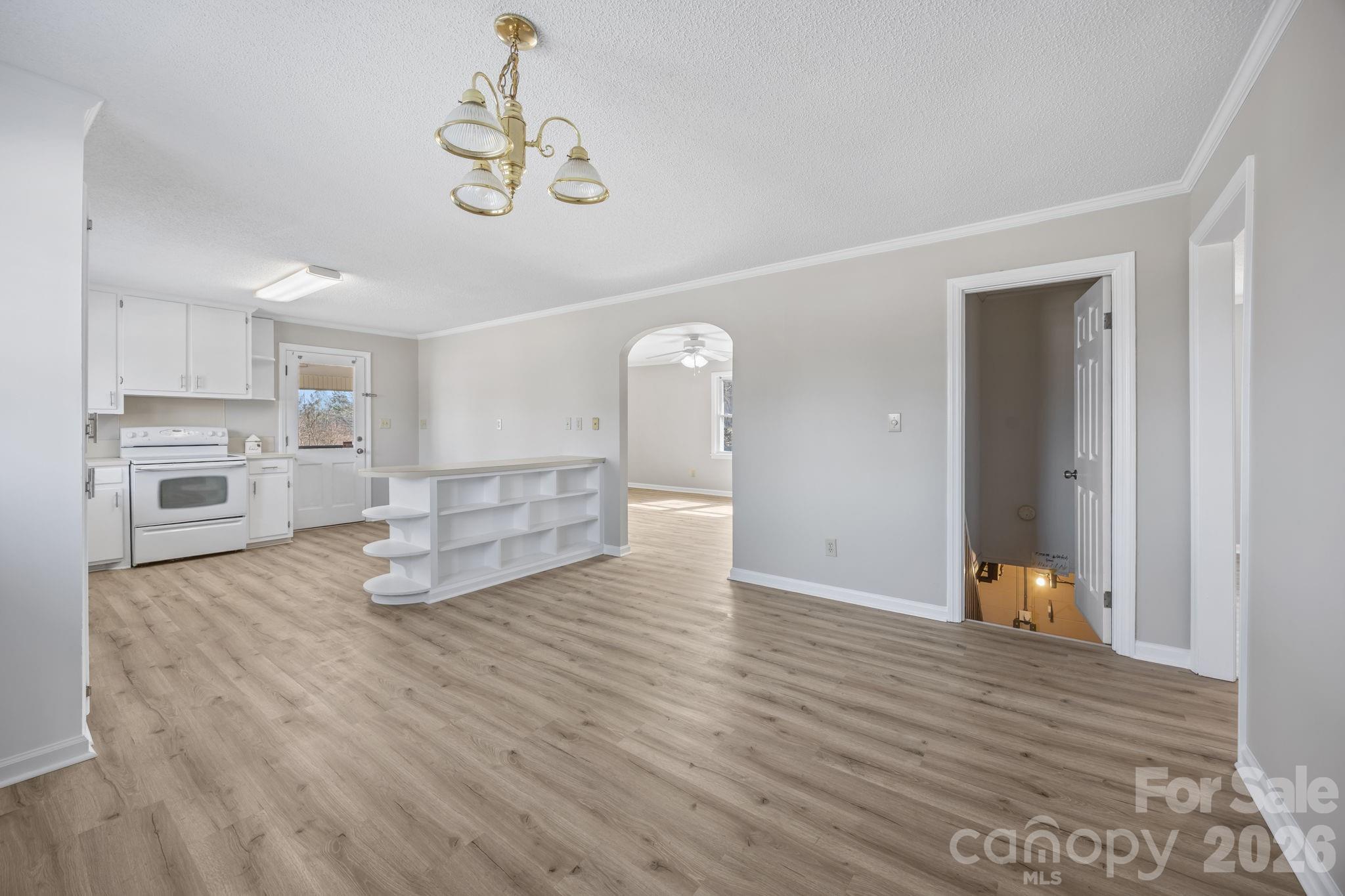 33633 Mann Road Albemarle, NC 28001 - Photo 19 of 39 a view of a livingroom with wooden floor and a ceiling fan