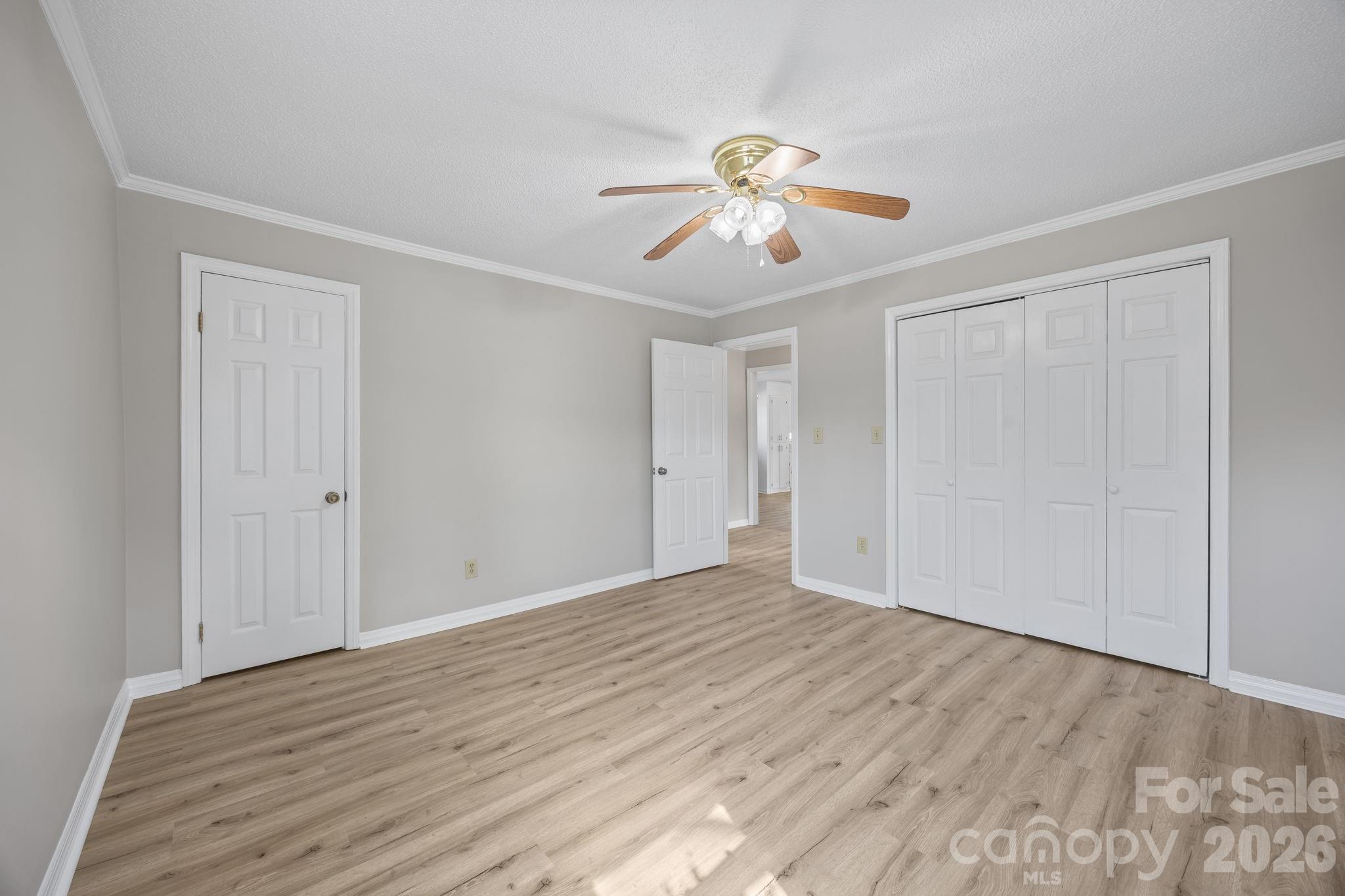 33633 Mann Road Albemarle, NC 28001 - Photo 27 of 39 a view of an empty room with wooden floor and ceiling fan