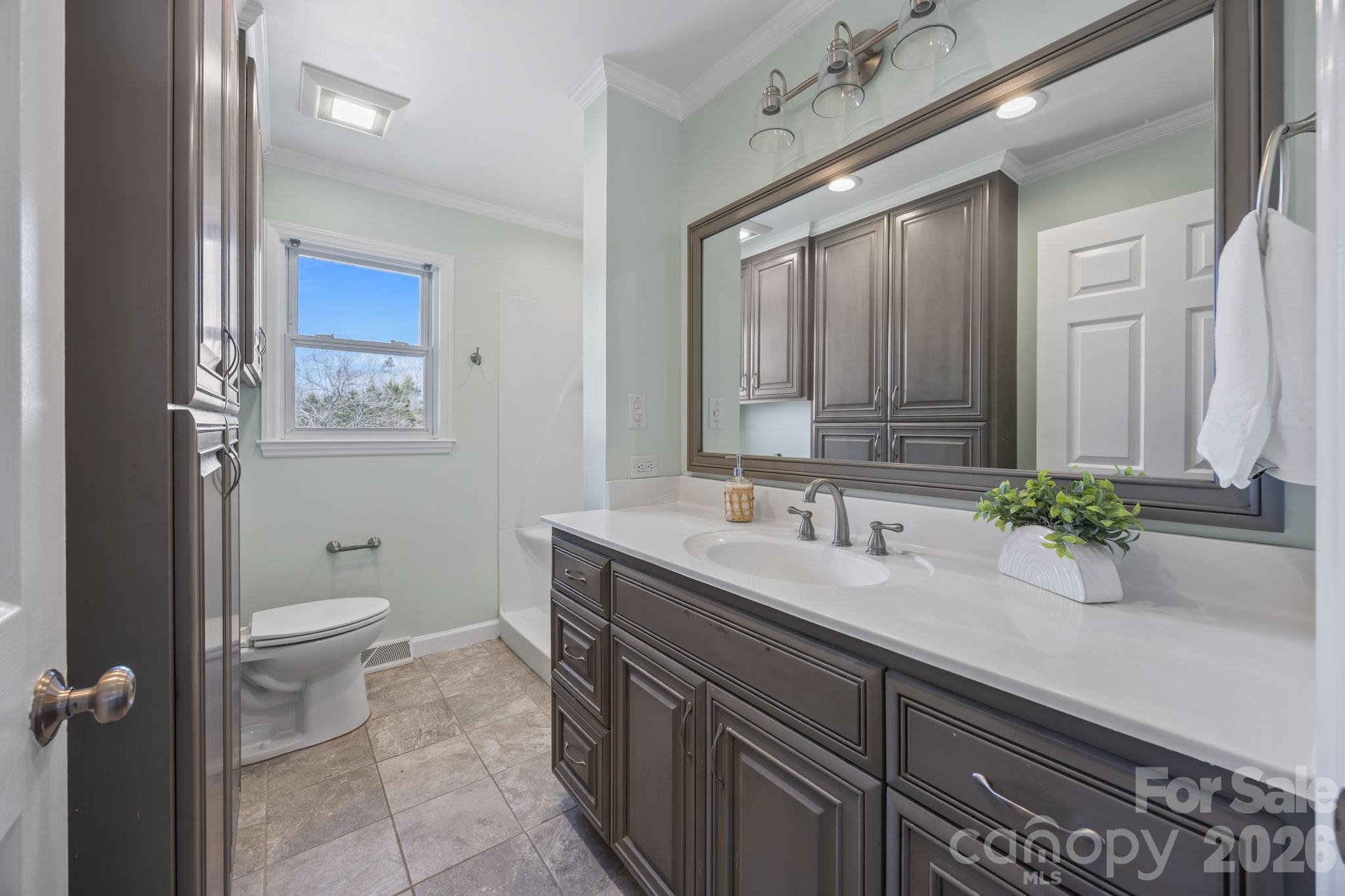 33633 Mann Road Albemarle, NC 28001 - Photo 31 of 39 a bathroom with a granite countertop sink and a mirror