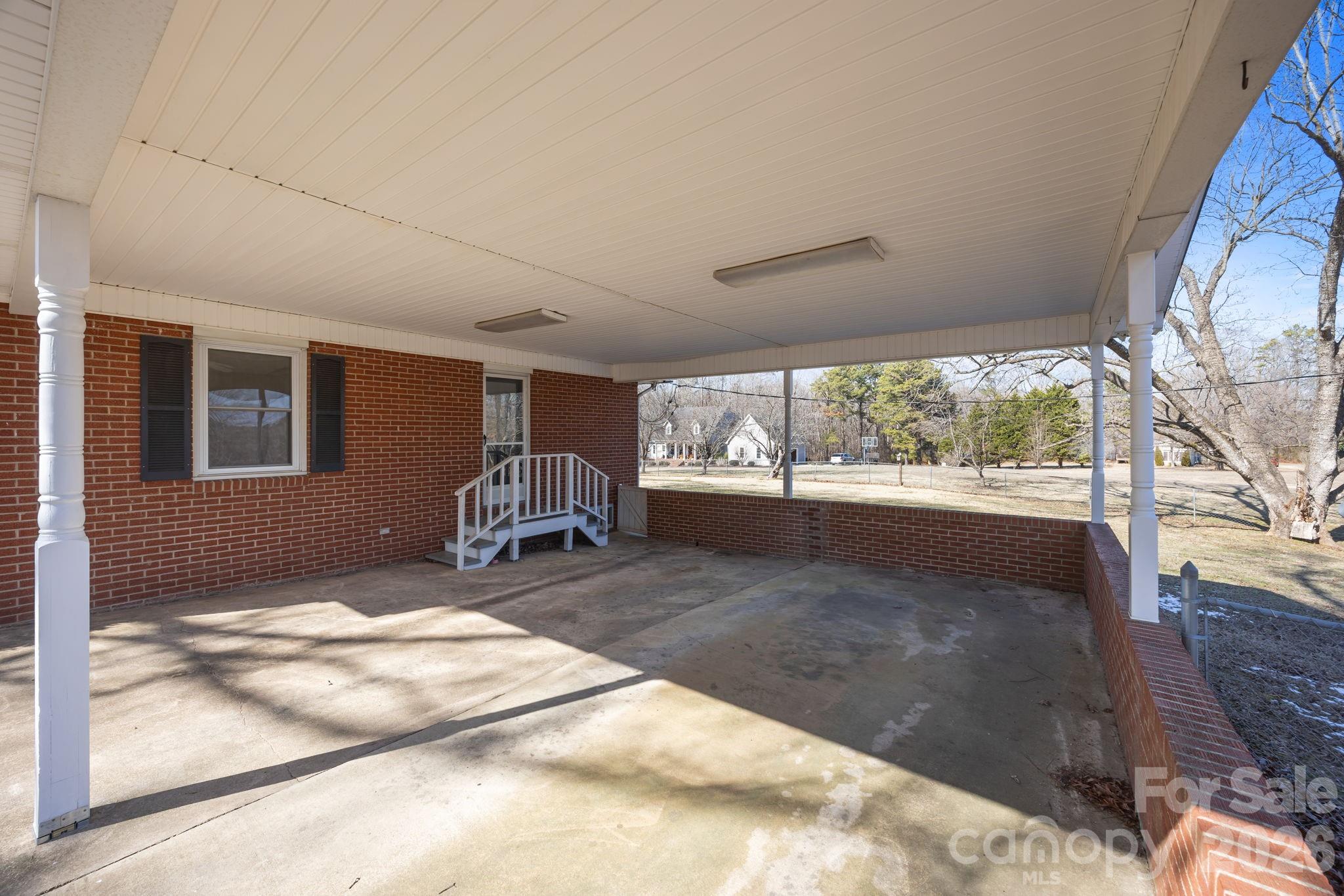 33633 Mann Road Albemarle, NC 28001 - Photo 8 of 39 a room with gym equipment and large windows
