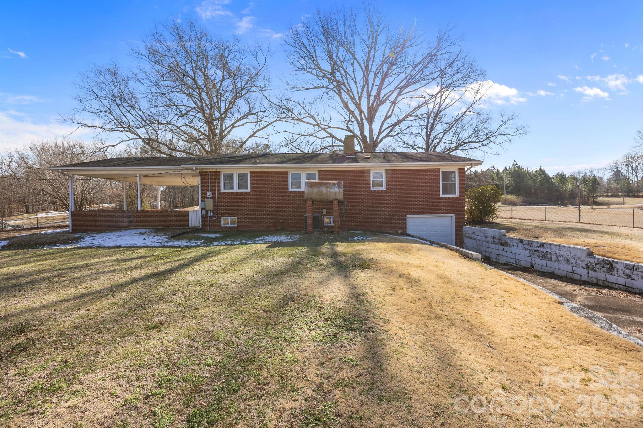 33633 Mann Road Albemarle, NC 28001 - Photo 10 of 39 a front view of a house with a yard and trees
