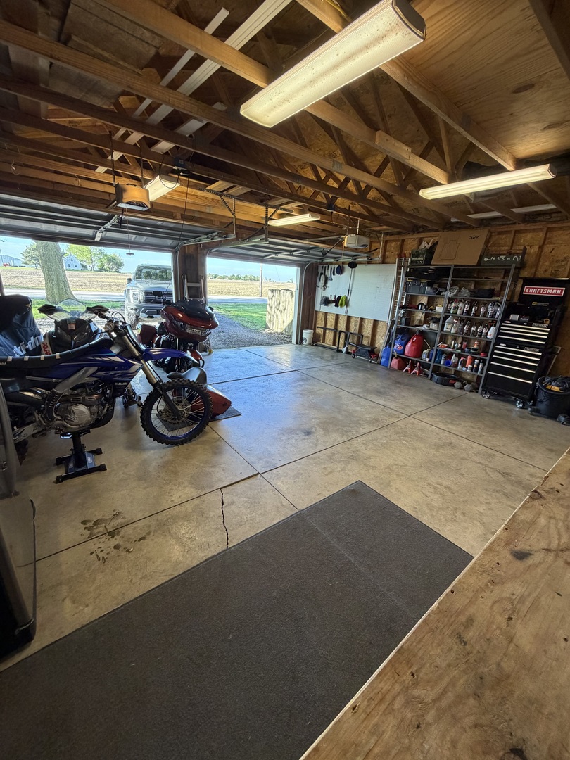 419 South Hamilton Street McLean, IL 61754 - Photo 38 of 41 a view of a garage with a bike and wooden roof