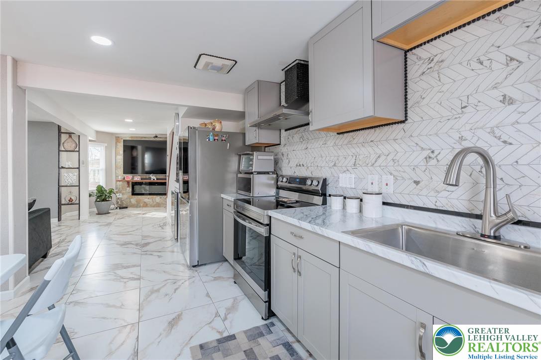 38 Water Street Wind Gap, PA 18091 - Photo 11 of 37 a kitchen with stainless steel appliances granite countertop a sink and cabinets