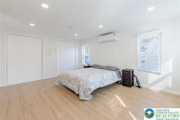 a spacious bedroom with a bed and a couch