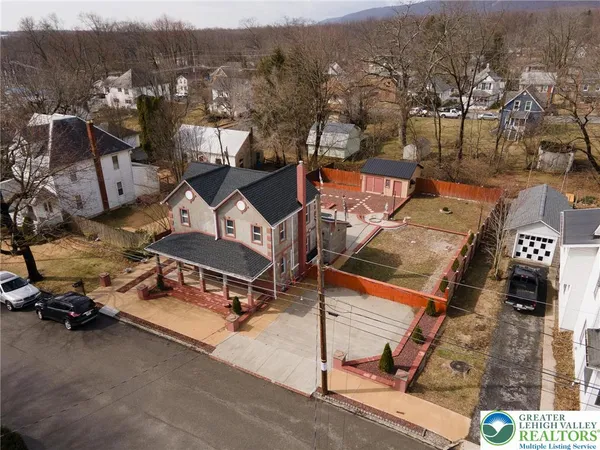an aerial view of a house with a yard