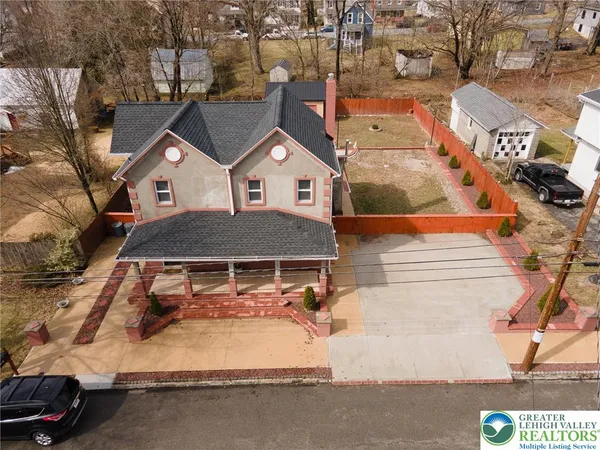 an aerial view of a house with a yard