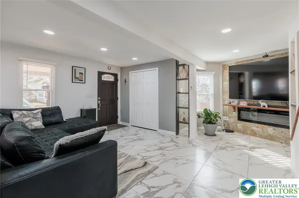 a living room with furniture and kitchen view