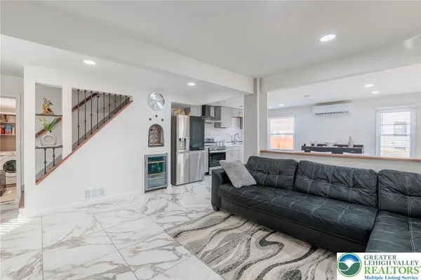 a kitchen with stainless steel appliances granite countertop a sink a stove a microwave a dining table and chairs