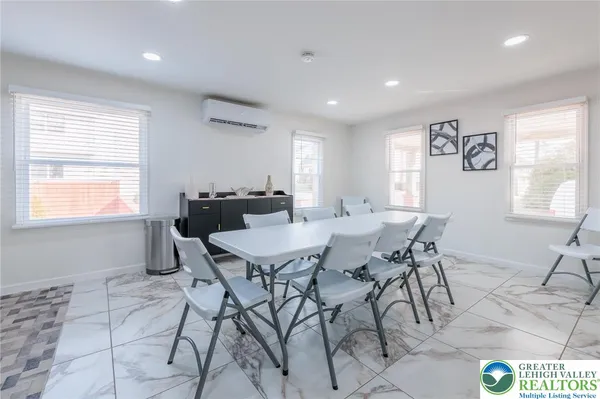 a large kitchen with a table and chairs in it