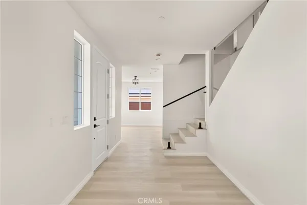 a view of an entryway with wooden floor