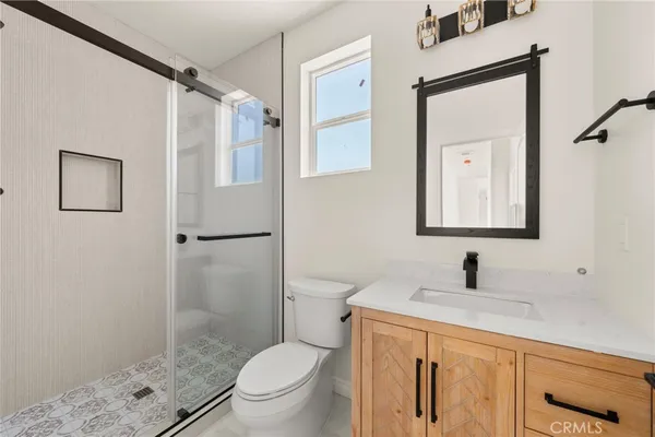 a bathroom with a granite countertop toilet sink and shower