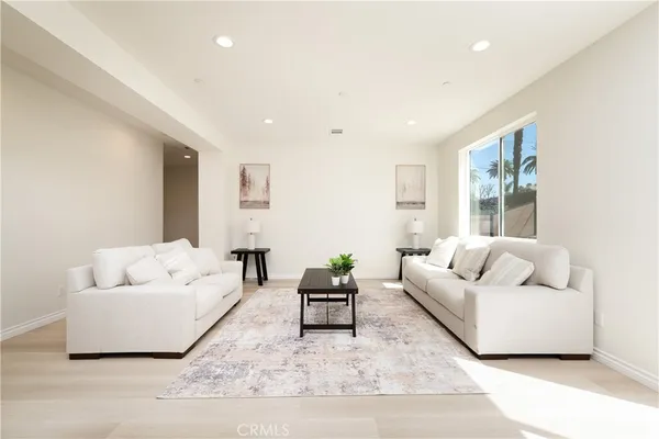 a living room with furniture and white walls