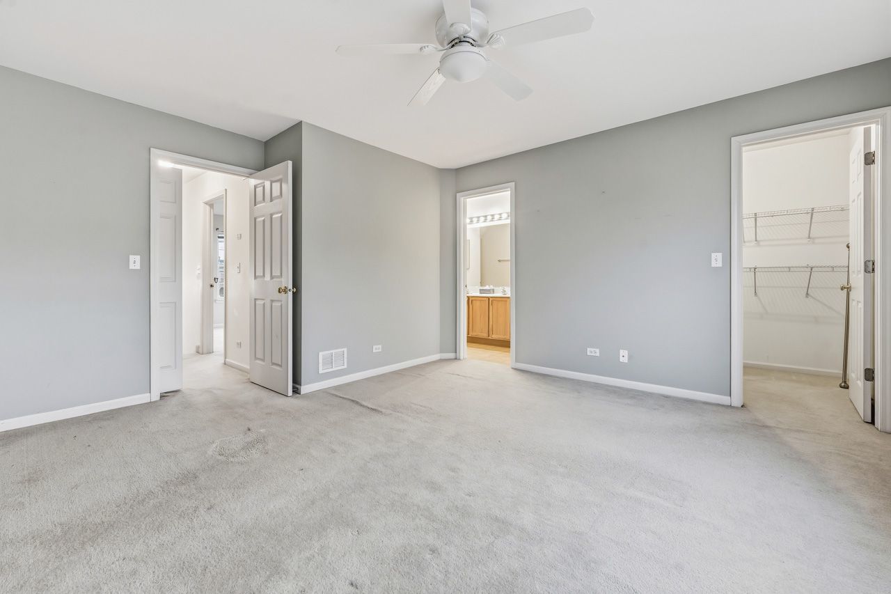 335 Holiday Lane Round Lake, IL 60073 - Photo 12 of 25 a view of an empty room and a ceiling fan