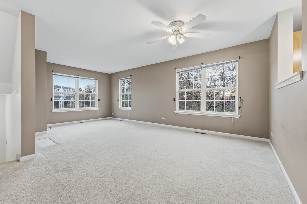 335 Holiday Lane Round Lake, IL 60073 - Photo 2 of 25 a view of an empty room with windows