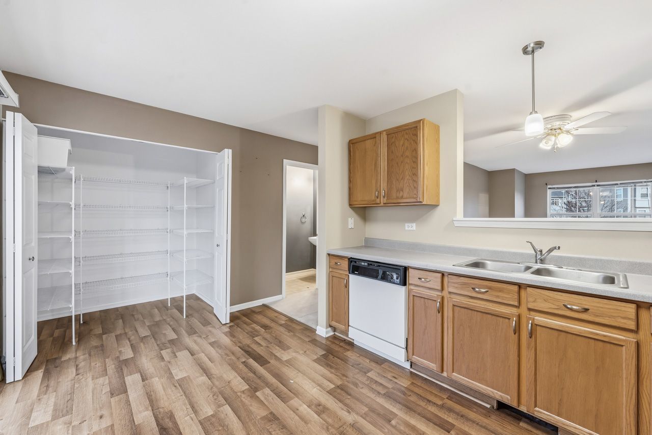 335 Holiday Lane Round Lake, IL 60073 - Photo 8 of 25 a kitchen with a sink cabinets and wooden floor