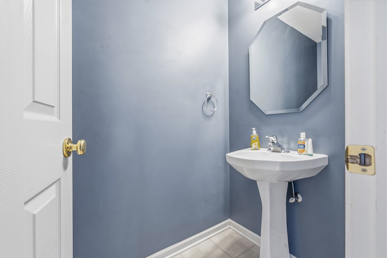 335 Holiday Lane Round Lake, IL 60073 - Photo 10 of 25 a bathroom with a sink and mirror