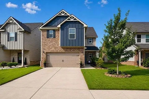 a front view of a house with a yard