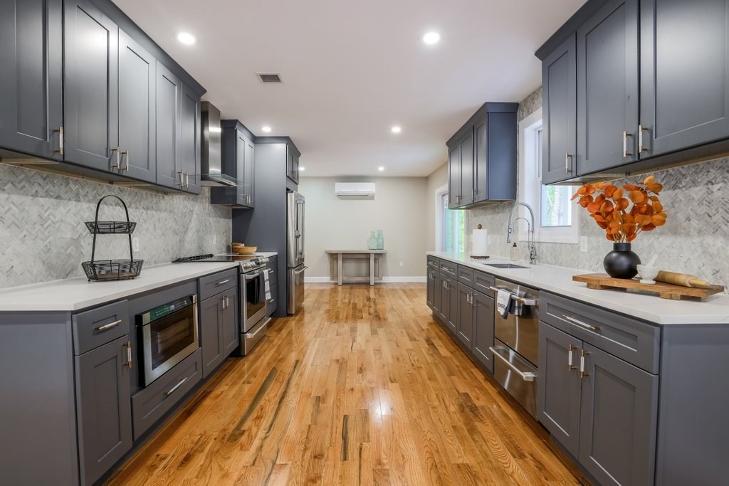 63 King Road Charlton, MA 01507 - Photo 18 of 40 a kitchen with stainless steel appliances granite countertop wooden cabinets a stove top oven a sink and dishwasher