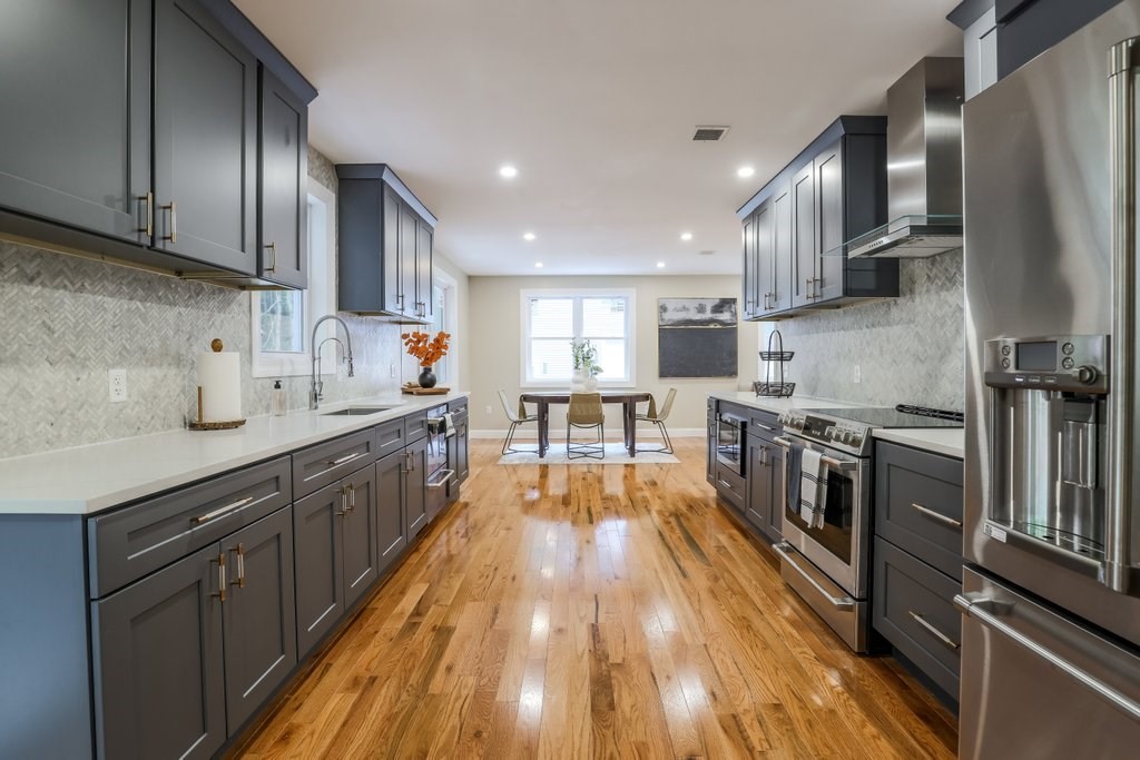 63 King Road Charlton, MA 01507 - Photo 19 of 40 a large kitchen with stainless steel appliances wooden floor a stove and a sink