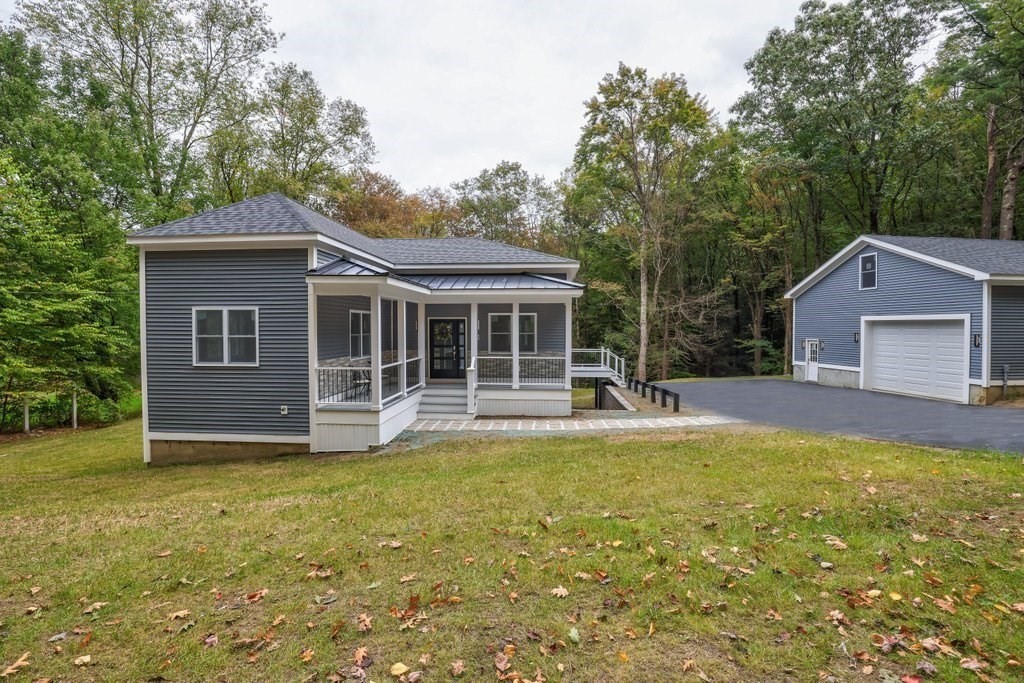 63 King Road Charlton, MA 01507 - Photo 3 of 40 a view of a house with a large window and a yard with plants