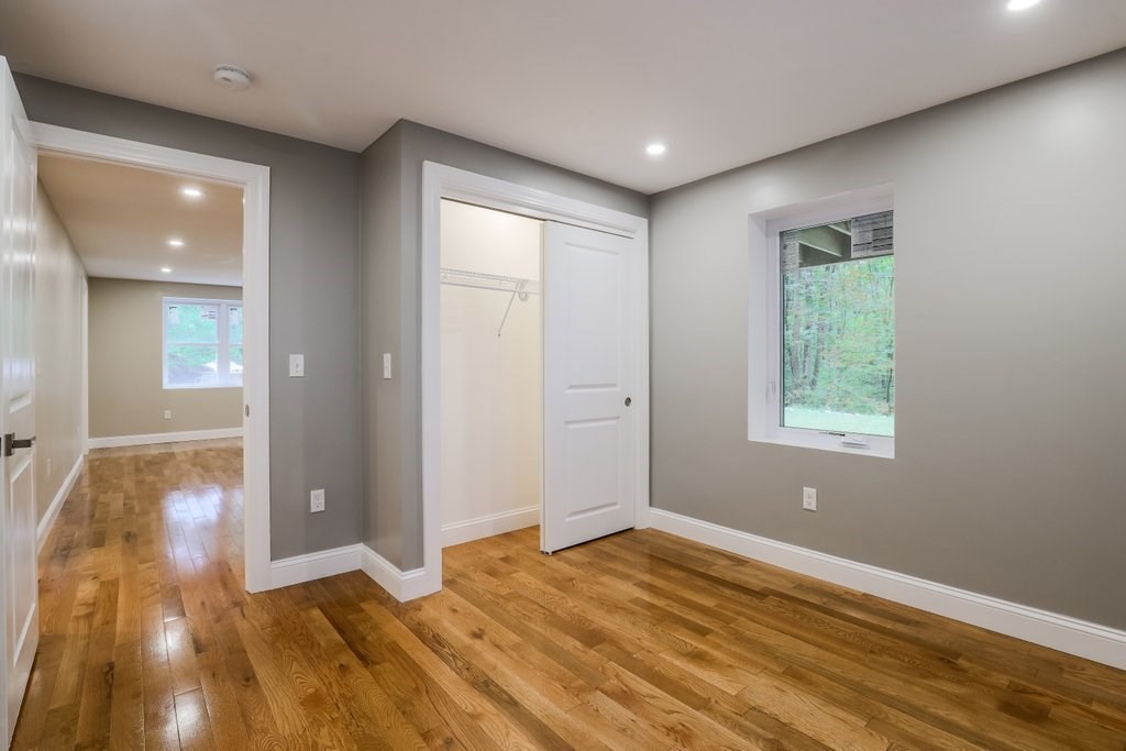 63 King Road Charlton, MA 01507 - Photo 32 of 40 an empty room with wooden floor and windows