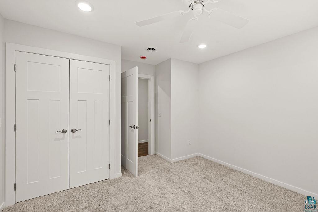 3971 Haines Road Hermantown, MN 55811 - Photo 29 of 34 Neutral-toned room with light gray walls, plush gray carpeting, and recessed ceiling lighting