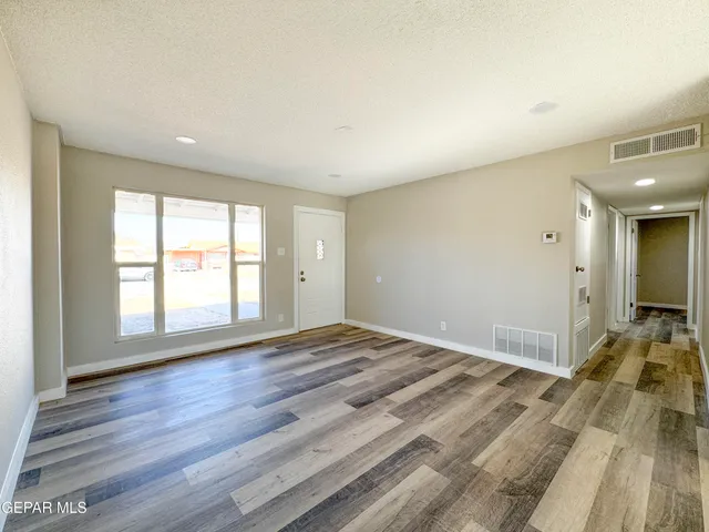 a kitchen with white cabinets and appliances
