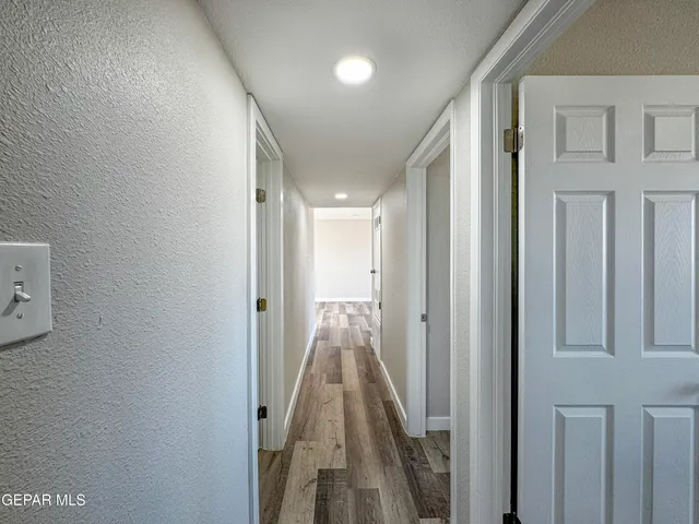 a bathroom with a granite countertop sink a mirror and shower