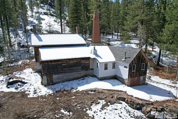 a view of a house with a sink and wooden fence
