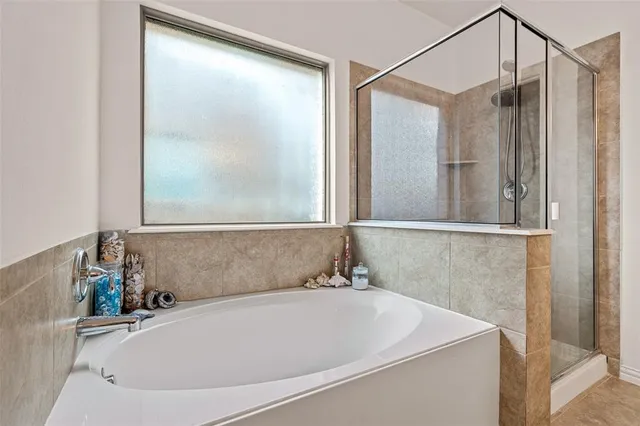a bathroom with a tub sink and mirror