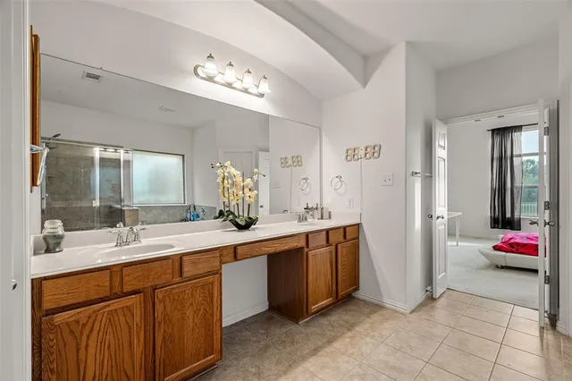 a bathroom with a sink mirror and toilet