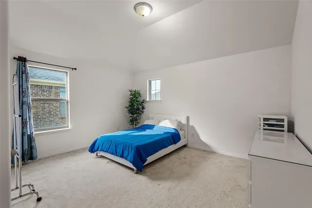 a spacious bedroom with a bed and a window