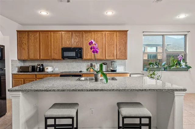 a kitchen with sink stove and cabinets