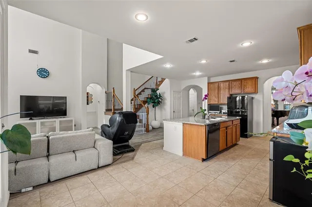a kitchen sink a counter space and a potted plant