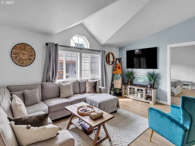 a living room with furniture a flat screen tv and a large window