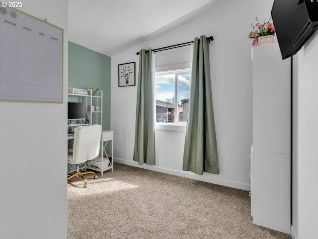 a view of a workspace with a window and bathroom