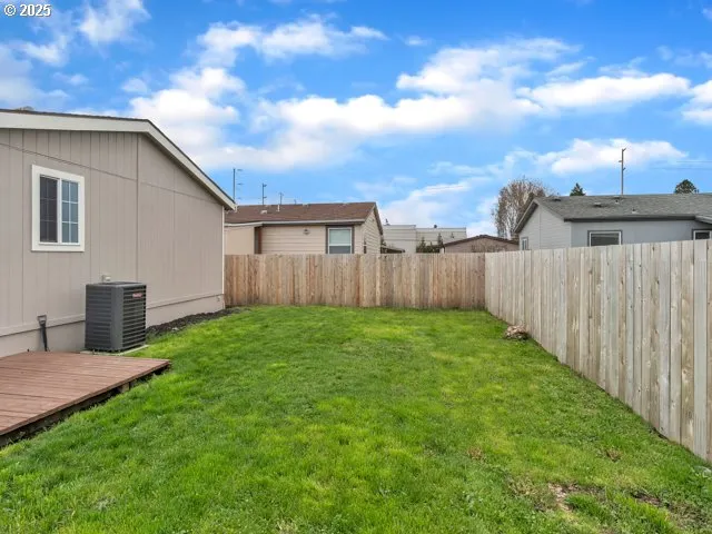 a view of a backyard with wooden fence