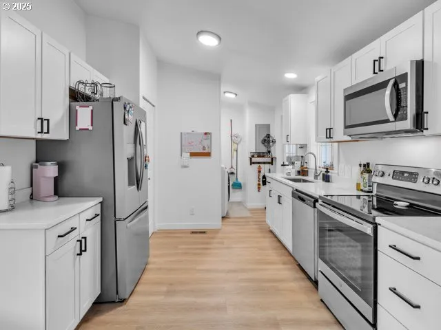 a kitchen with stainless steel appliances granite countertop a refrigerator sink and microwave